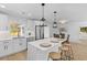 Open kitchen with a waterfall island and seating that flows seamlessly into the dining area at 671 Riley Rd, Charleston, SC 29412