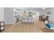 Open-concept kitchen with stainless steel appliances, white cabinetry, and a breakfast bar at 671 Riley Rd, Charleston, SC 29412