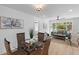 Open-concept living room and dining area with bright natural light and modern decor at 671 Riley Rd, Charleston, SC 29412
