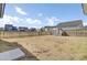View of fenced backyard with grass and playground equipment at 69 Arrowwood Way, Summerville, SC 29485