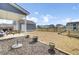 View of backyard with detached garage, partially covered patio, and wood fencing at 69 Arrowwood Way, Summerville, SC 29485