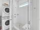 Modern bathroom with a tiled walk-in shower, glass door and stacked washer and dryer at 69 Arrowwood Way, Summerville, SC 29485