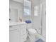 Bathroom featuring vanity with sink, toilet, shower with glass door and window for natural light at 69 Arrowwood Way, Summerville, SC 29485