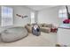 Bright bonus room featuring a comfortable couch and beanbag with two large windows at 69 Arrowwood Way, Summerville, SC 29485