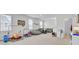 Spacious bonus room with lots of natural light, seating, toys, and a door to a bathroom at 69 Arrowwood Way, Summerville, SC 29485