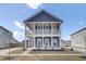Charming two-story home with a double porch, blue siding, and nicely landscaped yard at 69 Arrowwood Way, Summerville, SC 29485