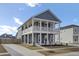 Charming two-story home with a double porch, blue siding, and nicely landscaped yard at 69 Arrowwood Way, Summerville, SC 29485