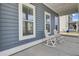 View of front porch with blue siding and two white rocking chairs at 69 Arrowwood Way, Summerville, SC 29485