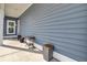 Front porch of the home with blue siding and planters at 69 Arrowwood Way, Summerville, SC 29485
