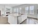 Open kitchen with a center island, stainless steel dishwasher, and view to the cozy living room at 69 Arrowwood Way, Summerville, SC 29485
