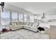 Bright, open-concept living room with large windows and a seamless flow into the modern kitchen at 69 Arrowwood Way, Summerville, SC 29485