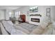 Cozy living room featuring a fireplace, mounted TV, piano, and comfortable seating area at 69 Arrowwood Way, Summerville, SC 29485