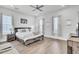 Bright main bedroom with wood floors, ceiling fan, ample windows, and a walk in closet at 69 Arrowwood Way, Summerville, SC 29485