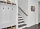 Mudroom with storage shelving, hooks, and baskets by the staircase at 69 Arrowwood Way, Summerville, SC 29485