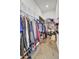 Organized walk-in closet with ample hanging space and storage shelves with wood-look flooring at 69 Arrowwood Way, Summerville, SC 29485