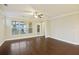 Bright living room features hardwood floors, large window, and ceiling fan at 710 Quintan St, Summerville, SC 29486