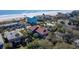 Beachfront homes surrounded by lush greenery and palm trees with ocean views at 716 E Arctic Ave, Folly Beach, SC 29439