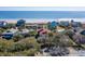 Coastal homes framed by trees, offering stunning ocean views and beachfront access at 716 E Arctic Ave, Folly Beach, SC 29439