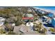 Gorgeous aerial view of a coastal neighborhood featuring colorful homes, lush greenery, and pristine sandy beaches at 716 E Arctic Ave, Folly Beach, SC 29439