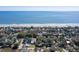 An elevated coastal view showing homes bordering a scenic beach with a clear view of the ocean at 716 E Arctic Ave, Folly Beach, SC 29439