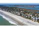 Aerial shot showcases beach houses lining a beautiful sandy beach and ocean coastline at 716 E Arctic Ave, Folly Beach, SC 29439