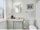 Bathroom with a single sink vanity, toilet and shower with a white patterned curtain at 716 E Arctic Ave, Folly Beach, SC 29439