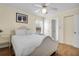 Bright bedroom featuring a full-sized bed, wood floors, ceiling fan and neutral walls at 716 E Arctic Ave, Folly Beach, SC 29439