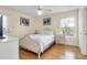 Bright bedroom featuring a full-sized bed, wood floors, ceiling fan and neutral walls at 716 E Arctic Ave, Folly Beach, SC 29439