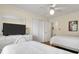 Bright bedroom featuring two twin beds, wood floors, ceiling fan and neutral walls at 716 E Arctic Ave, Folly Beach, SC 29439