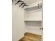 Walk in closet featuring wood floors, hanging rods and shelves for organization and storage at 716 E Arctic Ave, Folly Beach, SC 29439