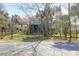 A picturesque view of a home surrounded by lush trees and greenery at 716 E Arctic Ave, Folly Beach, SC 29439