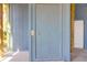 Exterior shot of a light blue door with a knob and a bolt at 716 E Arctic Ave, Folly Beach, SC 29439