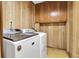 Functional laundry room with washer and dryer, wood paneling and plenty of storage space at 716 E Arctic Ave, Folly Beach, SC 29439