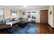Comfortable living room includes a gray sectional sofa and hardwood floors with a blue area rug at 716 E Arctic Ave, Folly Beach, SC 29439