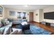 Cozy living room with a large sectional sofa, hardwood floors, and a view of the balcony at 716 E Arctic Ave, Folly Beach, SC 29439