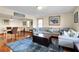 Inviting living room boasts a large sectional sofa, hardwood floors, and a dining table at 716 E Arctic Ave, Folly Beach, SC 29439