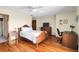 Spacious bedroom with hardwood floors, ceiling fan, a desk area, and ample natural light at 716 E Arctic Ave, Folly Beach, SC 29439