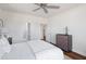 Bright bedroom featuring white walls, wood floors, and a ceiling fan plus a view into the bathroom at 718 Minton Rd, Charleston, SC 29412