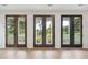 Living space featuring three sets of brown french doors that lead to patio at 722 Minton Rd, Charleston, SC 29412