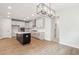 Spacious kitchen with stainless appliances, white cabinets, dark island and wood floors at 724 Minton Rd, Charleston, SC 29412