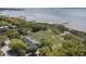 Aerial view overlooking a home with lush trees and foliage, and a beautiful coastline and harbor beyond at 750 Atlantic St, Mount Pleasant, SC 29464
