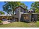 View of the backyard with a brick patio, grill, wood storage, and beautiful garden at 750 Atlantic St, Mount Pleasant, SC 29464
