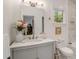 Bright bathroom showcasing a vanity with countertop sink and a window, decorated with elegant floral accents at 750 Atlantic St, Mount Pleasant, SC 29464