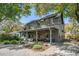 Charming two-story home featuring a welcoming front porch and meticulously landscaped front yard at 750 Atlantic St, Mount Pleasant, SC 29464