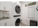 Convenient laundry room with stacked washer/dryer and ample cabinet space at 750 Atlantic St, Mount Pleasant, SC 29464