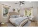Airy main bedroom with a tufted headboard, natural light from many windows and light blue accents at 750 Atlantic St, Mount Pleasant, SC 29464