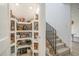 Well-organized pantry with custom shelving offering ample storage, adjacent to the staircase at 750 Atlantic St, Mount Pleasant, SC 29464