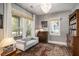 Bright sitting room with large windows and a cozy grey settee. Perfect space for relaxation or conversation at 750 Atlantic St, Mount Pleasant, SC 29464