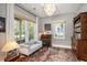Bright sitting room with large windows and a cozy grey settee. Perfect space for relaxation or conversation at 750 Atlantic St, Mount Pleasant, SC 29464