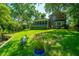 Lush backyard with mature trees and screened-in porch on brick home at 750 Lakenheath Dr, Mount Pleasant, SC 29464